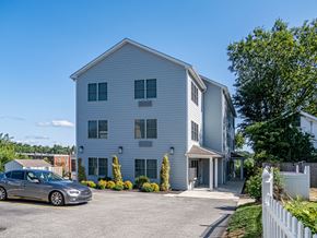 Philadelphia apartment for rent - a white building with a car parked in front of it