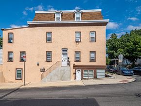 Philadelphia apartment for rent - A brown building with a white door and windows.