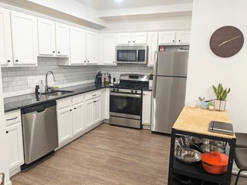 Philadelphia apartment for rent - a kitchen with stainless steel appliances and white cabinets