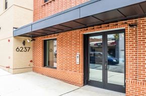 Philadelphia apartment for rent - A red brick building with a black awning and a glass door.