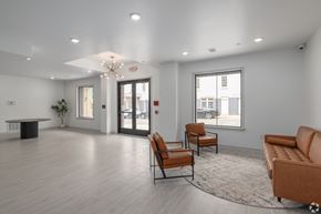 Philadelphia apartment for rent - A spacious waiting room with a table, chairs, and a large window.