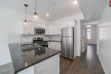 Philadelphia apartment for rent - a kitchen with white cabinets and a stainless steel refrigerator