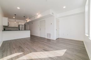 Philadelphia apartment for rent - A spacious room with wooden flooring and white walls.