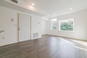 Philadelphia apartment for rent - A room with a white door and a window with a view of trees.
