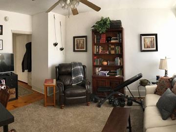 Philadelphia apartment for rent - A living room with a black leather chair and a wooden bookshelf.