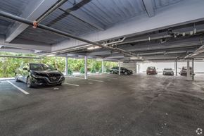 Philadelphia apartment for rent - A black car is parked in a spacious, multi-level parking garage.