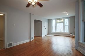 Chicago apartment for rent - an empty living room with wood floors and a ceiling fan