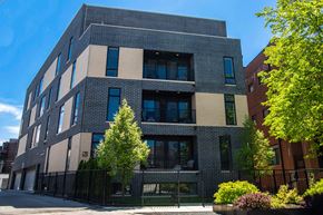Chicago apartment for rent - a large brick building with trees in front of it