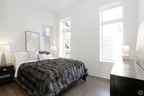 Chicago apartment for rent - a bedroom with a bed and two windows