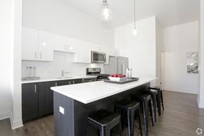 Chicago apartment for rent - a kitchen with an island and bar stools