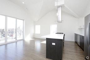 Chicago apartment for rent - an empty room with a kitchen and a large window