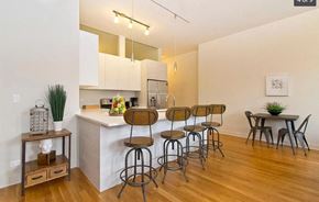 Chicago apartment for rent - a kitchen with a bar and a table with chairs