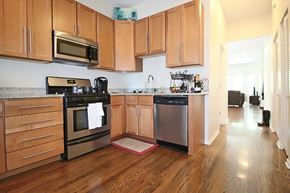 Chicago apartment for rent - a kitchen with wooden cabinets and stainless steel appliances