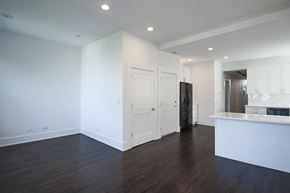 Chicago apartment for rent - an empty living room and kitchen with white walls and wood floors