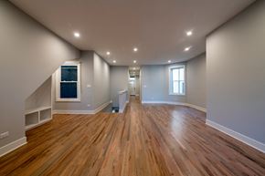 Chicago apartment for rent - the living room and dining room of a new home with wood floors and white walls