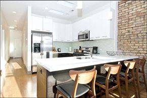 Chicago apartment for rent - a large kitchen with a counter top and chairs