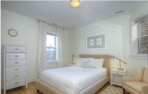 Chicago apartment for rent - a white bedroom with a bed and a chair
