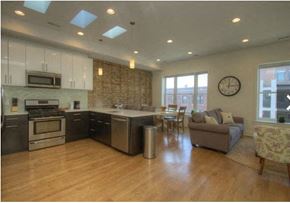 Chicago apartment for rent - a large living room with a kitchen and a table