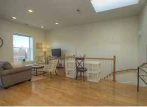 Chicago apartment for rent - a living room with a couch and a table with chairs