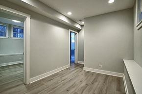 Chicago apartment for rent - a newly renovated living room and hallway with wood flooring