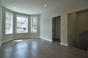 Chicago apartment for rent - an empty living room with wood floors and windows