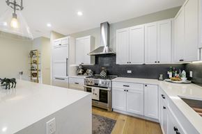 Chicago apartment for rent - a kitchen with white cabinets and a white counter top