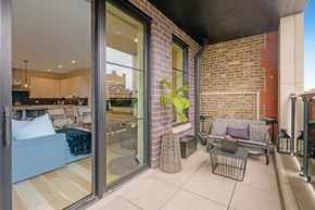 Chicago apartment for rent - a patio with a couch and a table and sliding glass doors