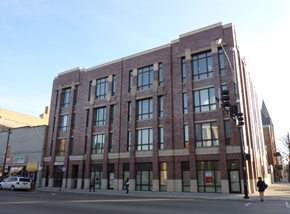 Chicago apartment for rent - a large brick building on the corner of a city street
