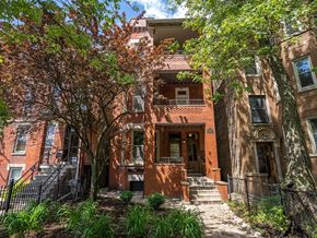Chicago apartment for rent - a red brick house with trees in front of it
