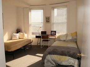Chicago apartment for rent - a bedroom with two beds and a desk with a laptop