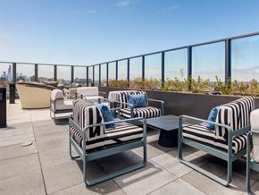 Chicago apartment for rent - a lounge area with chairs and tables on a balcony