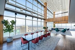 Winnipeg apartment for rent - A conference room with a long table and chairs with a view of the city outside the window.
