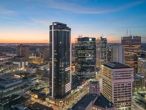 Winnipeg apartment for rent - A cityscape at dusk with buildings illuminated and a clear sky.