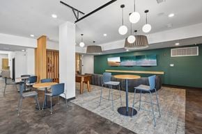 Valparaiso apartment for rent - A modern dining area with a wooden table and blue chairs.