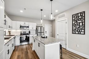 Valparaiso apartment for rent - A modern kitchen with white cabinets and a granite countertop.