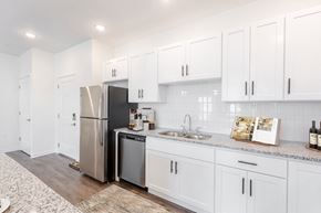 Westfield apartment for rent - A kitchen with white cabinets and a stainless steel refrigerator.