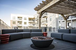 Noblesville apartment for rent - a patio with couches and a fire pit on a