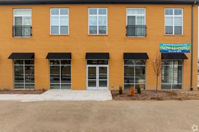 Indianapolis apartment for rent - A building with a blue sign that says "NOW LEASING" is shown.