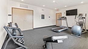 Kokomo apartment for rent - a gym with exercise equipment and a tv