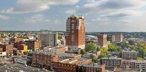 Manchester apartment for rent - an aerial view of a city with a tall building