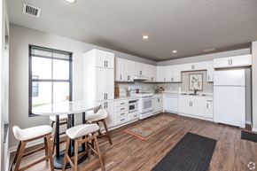 Ames townhouse for rent - A kitchen with white cabinets and a black and white checkered floor.