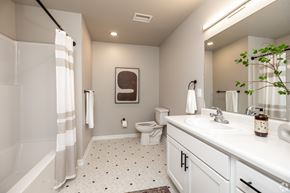 Ames townhouse for rent - A bathroom with a toilet, sink, and shower.