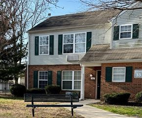 Bridgeville apartment for rent - A house with green shutters and a brick facade.