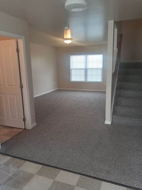 Scranton apartment for rent - an empty living room with a staircase in the background