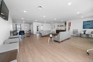 Cedar Rapids apartment for rent - a living room with couches and chairs and a tv