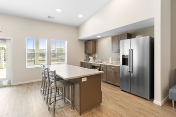 Waterloo apartment for rent - A kitchen with a table and chairs and a refrigerator.