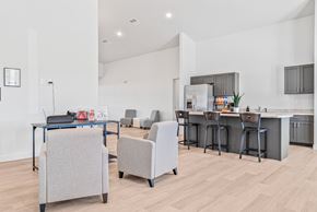 Howell apartment for rent - A modern kitchen with a dining table and chairs. at Union at Oak Grove, Howell, Michigan