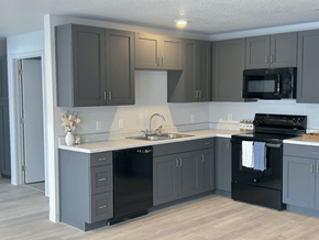 Des Moines apartment for rent - A kitchen with black appliances and cabinets at Union at Rivers Edge Apartments, Des Moines