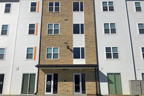 Bloomington apartment for rent - A building with a brown brick facade and white siding.at Union at Crescent, Bloomington, IN 47404