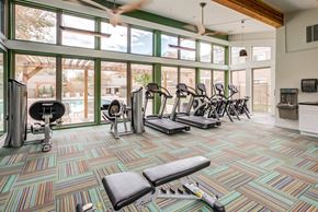 Lakewood apartment for rent - A gym with a variety of equipment including treadmills, weights, and exercise bikes at The Ranch at Bear Creek Apartments, Colorado, 80227